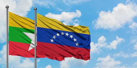 Myanmar and Venezuela flag waving in the wind against white cloudy blue sky together. Diplomacy concept, international relations.