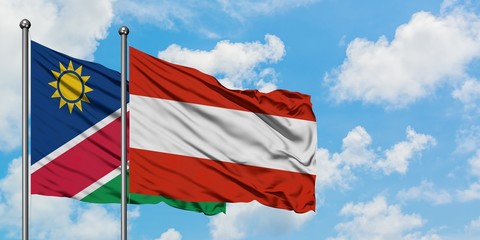 Namibia and Austria flag waving in the wind against white cloudy blue sky together. Diplomacy concept, international relations.