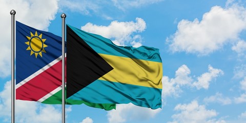 Namibia and Bahamas flag waving in the wind against white cloudy blue sky together. Diplomacy concept, international relations.