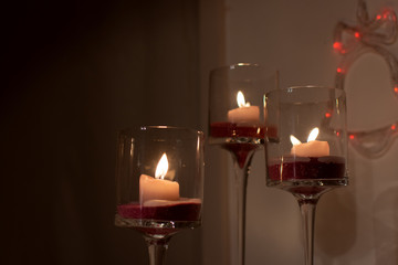 Bruges/Belgium - 12.24.2018: Three candles in glasses for Christmas dinner