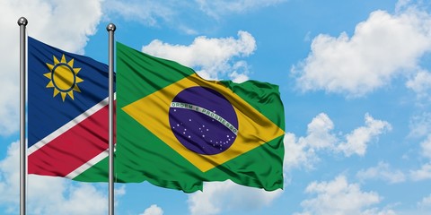 Namibia and Brazil flag waving in the wind against white cloudy blue sky together. Diplomacy concept, international relations.