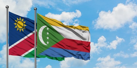 Namibia and Comoros flag waving in the wind against white cloudy blue sky together. Diplomacy concept, international relations.
