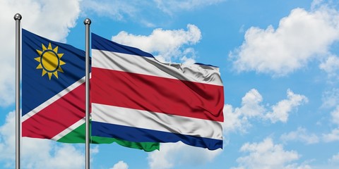 Namibia and Costa Rica flag waving in the wind against white cloudy blue sky together. Diplomacy concept, international relations.