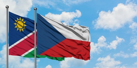 Namibia and Czech Republic flag waving in the wind against white cloudy blue sky together. Diplomacy concept, international relations.