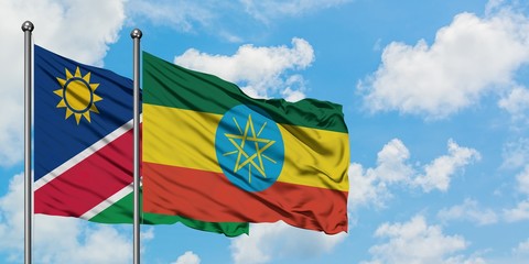 Namibia and Ethiopia flag waving in the wind against white cloudy blue sky together. Diplomacy concept, international relations.