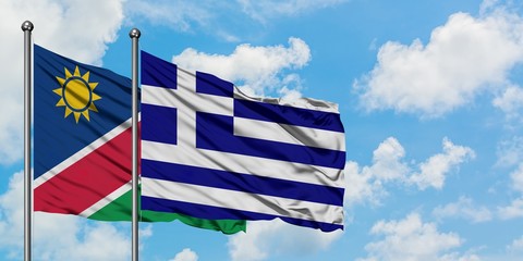 Namibia and Greece flag waving in the wind against white cloudy blue sky together. Diplomacy concept, international relations.