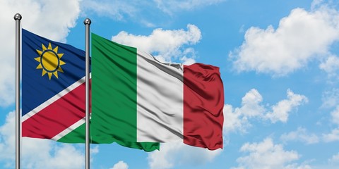 Namibia and Italy flag waving in the wind against white cloudy blue sky together. Diplomacy concept, international relations.