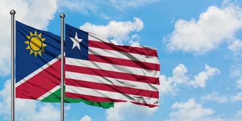 Namibia and Liberia flag waving in the wind against white cloudy blue sky together. Diplomacy concept, international relations.