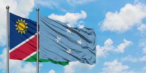 Namibia and Micronesia flag waving in the wind against white cloudy blue sky together. Diplomacy concept, international relations.