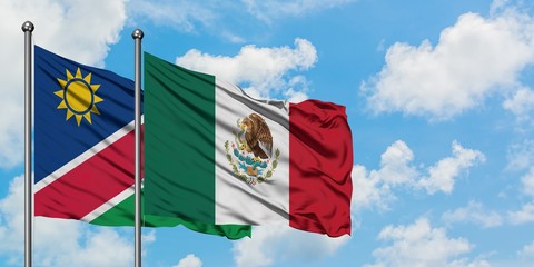 Namibia and Mexico flag waving in the wind against white cloudy blue sky together. Diplomacy concept, international relations.