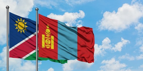 Namibia and Mongolia flag waving in the wind against white cloudy blue sky together. Diplomacy concept, international relations.