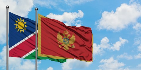 Namibia and Montenegro flag waving in the wind against white cloudy blue sky together. Diplomacy concept, international relations.