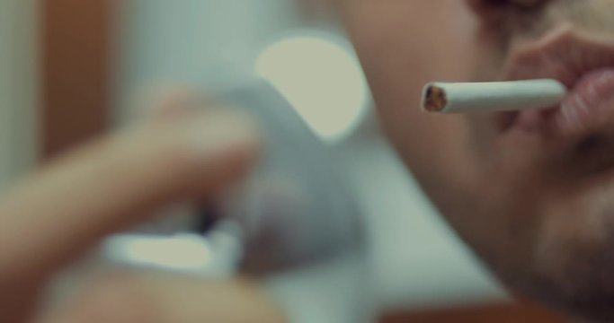 Burning cigarette with zippo lighter and smoking
