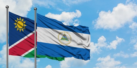Namibia and Nicaragua flag waving in the wind against white cloudy blue sky together. Diplomacy concept, international relations.