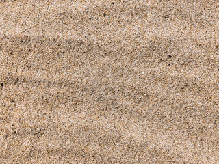 Sand texture. Golden beach sand close up. Background with sand, top view with copy space.