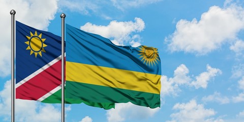Namibia and Rwanda flag waving in the wind against white cloudy blue sky together. Diplomacy concept, international relations.
