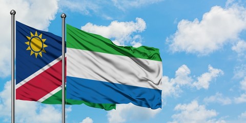 Namibia and Sierra Leone flag waving in the wind against white cloudy blue sky together. Diplomacy concept, international relations.