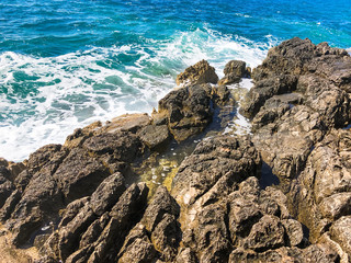 Background with sea and rocks. Postcard view with blue sea and rocky coast of the Mediterranean Sea