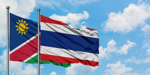 Namibia and Thailand flag waving in the wind against white cloudy blue sky together. Diplomacy concept, international relations.