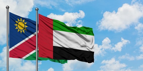 Namibia and United Arab Emirates flag waving in the wind against white cloudy blue sky together. Diplomacy concept, international relations.