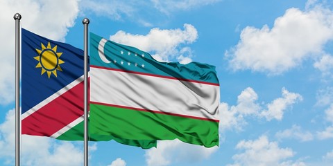 Namibia and Uzbekistan flag waving in the wind against white cloudy blue sky together. Diplomacy concept, international relations.