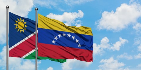 Namibia and Venezuela flag waving in the wind against white cloudy blue sky together. Diplomacy concept, international relations.