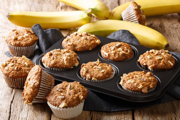Dietary healthy banana walnuts muffins close-up in a baking dish. horizontal