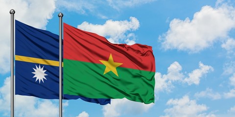 Nauru and Burkina Faso flag waving in the wind against white cloudy blue sky together. Diplomacy concept, international relations.