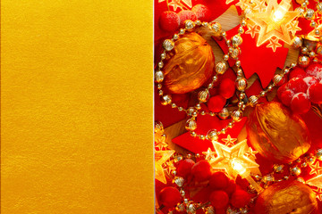 Festive Christmas golden background with red Xmas Decorations. Creative mock up for greeting card, party invitation.