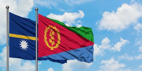 Nauru and Eritrea flag waving in the wind against white cloudy blue sky together. Diplomacy concept, international relations.