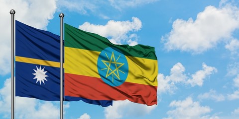 Nauru and Ethiopia flag waving in the wind against white cloudy blue sky together. Diplomacy concept, international relations.