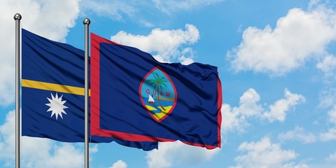 Nauru and Guam flag waving in the wind against white cloudy blue sky together. Diplomacy concept, international relations.