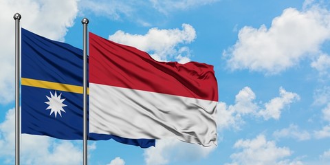 Nauru and Indonesia flag waving in the wind against white cloudy blue sky together. Diplomacy concept, international relations.