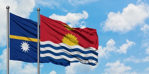 Nauru and Kiribati flag waving in the wind against white cloudy blue sky together. Diplomacy concept, international relations.