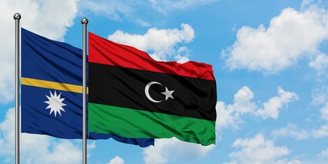 Nauru and Libya flag waving in the wind against white cloudy blue sky together. Diplomacy concept, international relations.