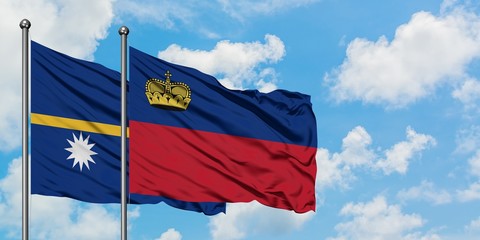 Nauru and Liechtenstein flag waving in the wind against white cloudy blue sky together. Diplomacy concept, international relations.