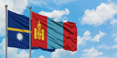 Nauru and Mongolia flag waving in the wind against white cloudy blue sky together. Diplomacy concept, international relations.