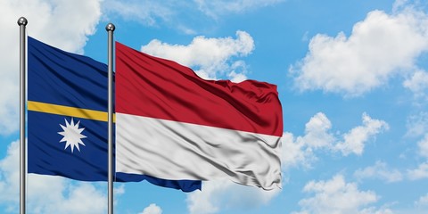 Nauru and Monaco flag waving in the wind against white cloudy blue sky together. Diplomacy concept, international relations.