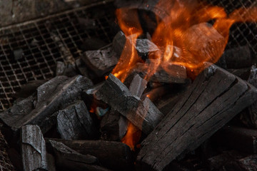 Charcoal burns in the grill