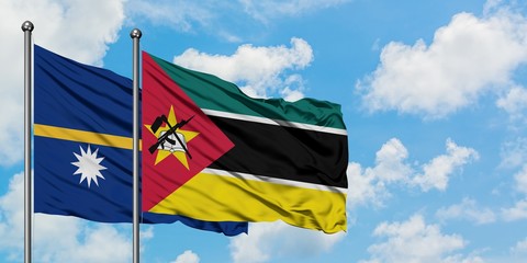 Nauru and Mozambique flag waving in the wind against white cloudy blue sky together. Diplomacy concept, international relations.
