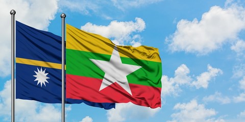 Nauru and Myanmar flag waving in the wind against white cloudy blue sky together. Diplomacy concept, international relations.