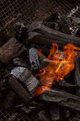 Charcoal burns in the grill