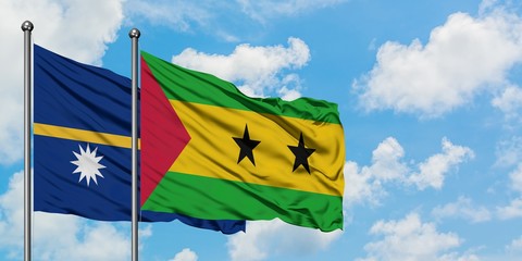Nauru and Sao Tome And Principe flag waving in the wind against white cloudy blue sky together. Diplomacy concept, international relations.
