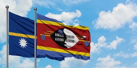 Nauru and Swaziland flag waving in the wind against white cloudy blue sky together. Diplomacy concept, international relations.