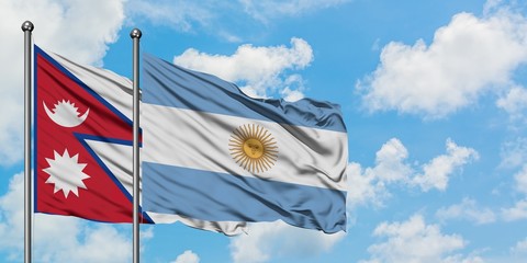 Nepal and Argentina flag waving in the wind against white cloudy blue sky together. Diplomacy concept, international relations.