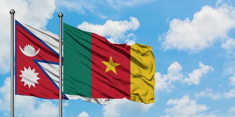 Nepal and Cameroon flag waving in the wind against white cloudy blue sky together. Diplomacy concept, international relations.
