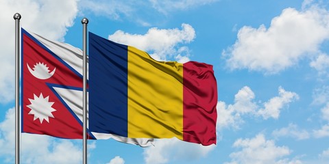 Nepal and Chad flag waving in the wind against white cloudy blue sky together. Diplomacy concept, international relations.
