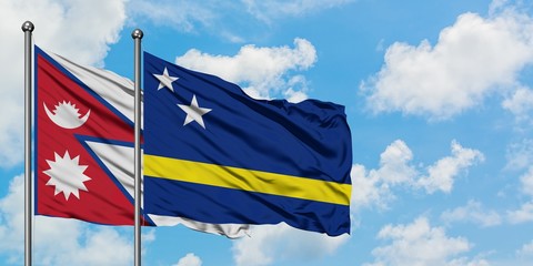 Nepal and Curacao flag waving in the wind against white cloudy blue sky together. Diplomacy concept, international relations.