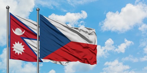 Nepal and Czech Republic flag waving in the wind against white cloudy blue sky together. Diplomacy concept, international relations.