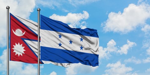 Nepal and Honduras flag waving in the wind against white cloudy blue sky together. Diplomacy concept, international relations.